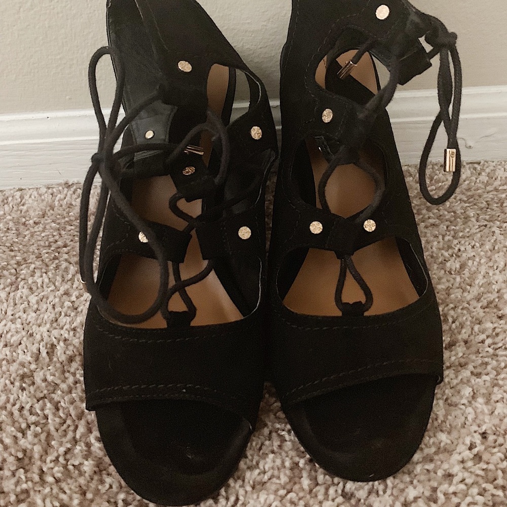 Strappy, black heeled, sandals.